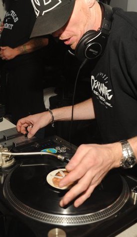 DJ Natural Nate® on the turntables close up, hands on the record